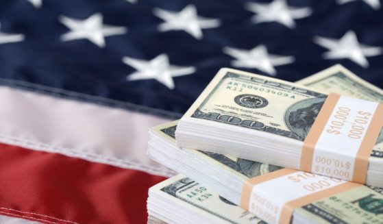 This Getty stock image shows a stack of cash on the U.S. flag.