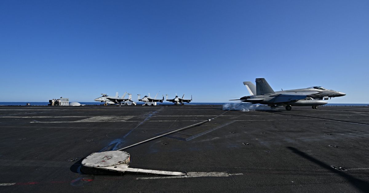 An F/A-18 Hornet fighter jet landing on the deck of the US Nimitz-class nuclear-powered aircraft carrier USS Harry S. Truman, during a NATO vigilance activity NEPTUNE SHIELD 2022 (NESH22) on eastern Mediterranean Sea on May 23, 2022. - NATO is conducting vigilance activity NEPTUNE SHIELD 2022 (NESH22), which integrates high-end maritime expeditionary strike capabilities of Sea, Air and Land assets. The activities are take place in the Baltic, Adriatic and Mediterranean Seas, from 17-31 May.