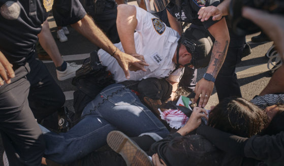 A New York City police officer subdues a pro-Palestinian protester as he pins him on the ground during a protest on May 31, 2024, in the Brooklyn borough of New York.