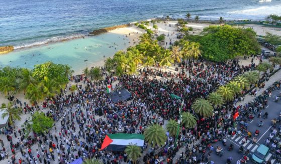 Protesters hold a rally to show support for Palestinians on a beach in Male, Maldives, on Oct. 14, 2023.