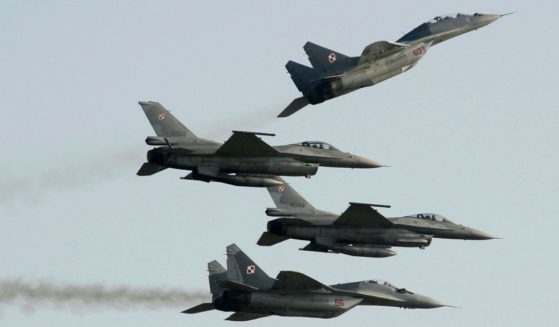 four Polish fighter jets flying during an air show