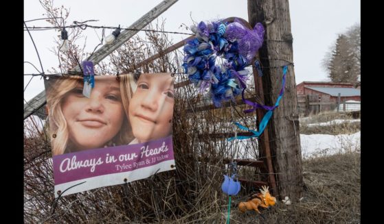 A picture of Tylee Ryan (L) and J.J. Vallow is seen on a fence opposite the property where their bodies were found in 2020, on April 4, 2023 in Rexburg, Idaho.