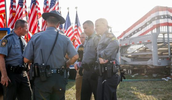Law enforcement agents stand near the stage of a campaign rally in Butler, Pennsylvania, where Republican presidential candidate and former President Donald Trump was targeted in an assassination attempt on Saturday.
