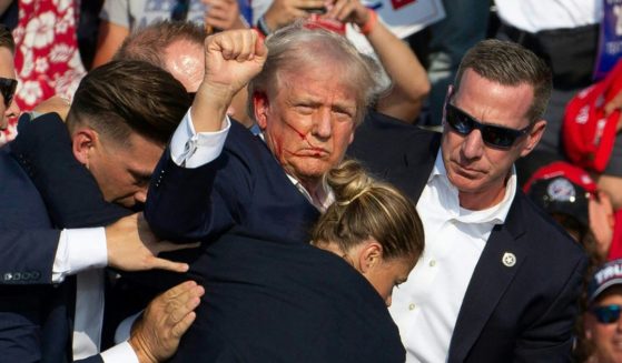 Republican candidate Donald Trump is seen with blood on his face surrounded by secret service agents as he is taken off the stage at a campaign event at Butler Farm Show Inc. in Butler, Pennsylvania, July 13, 2024.