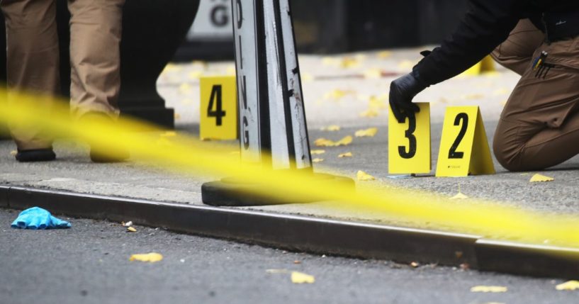 Police place bullet casing markers outside of a Hilton Hotel in Midtown Manhattan where United Healthcare CEO Brian Thompson was fatally shot on Wednesday.