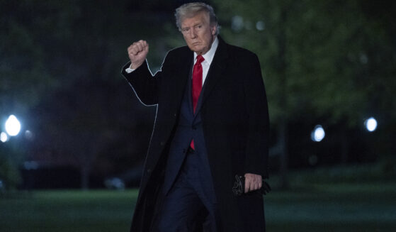 President Donald Trump gestures to reporters as he walks on the South Lawn of the White House in Washington, D.C., on Sunday.