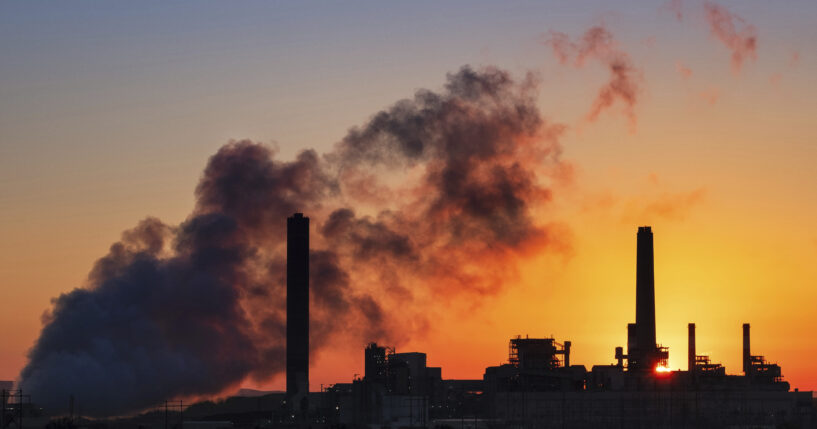 The Dave Johnson coal-fired power plant is silhouetted against the morning sun in Glenrock, Wyoming, on July 27, 2018.