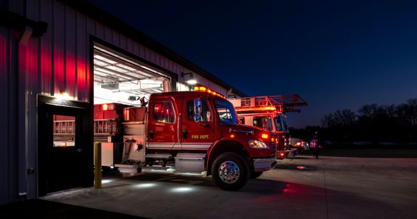 Fire trucks parked outside a station, ready to leave for an emergency.