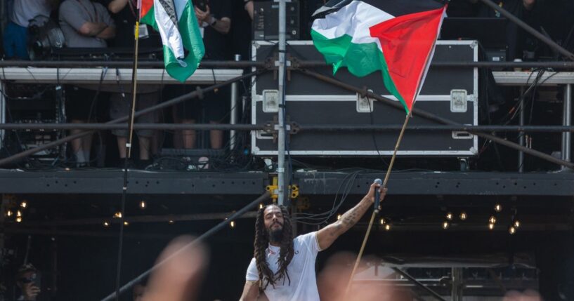 Bob Vylan waves a Palestinian flag as he performs on the West Holts stage during day four of Glastonbury Festival 2025 in Glastonbury, England on Saturday.