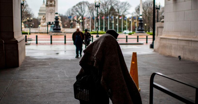 A homeless person walks out of Union Station as the train station is almost deserted by commuters during the usual rush hour in Washington, D.C., on March 25, 2020.