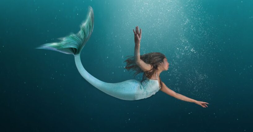 This image depicts a mermaid swimming in the ocean.