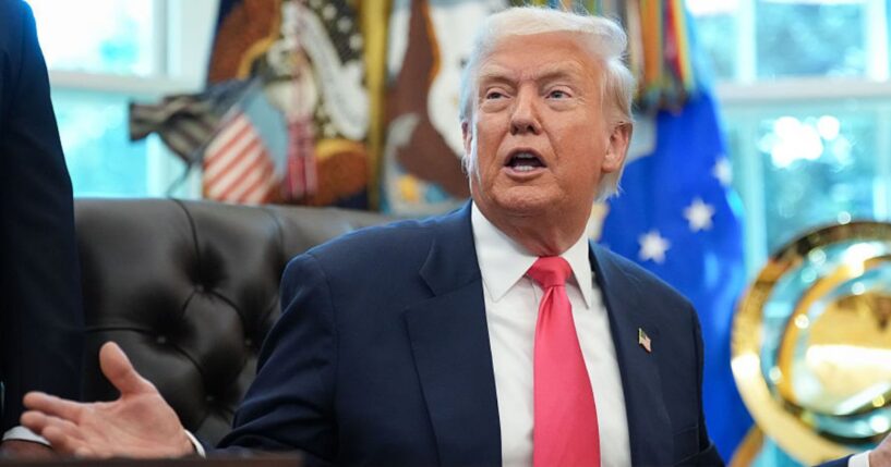 President Donald Trump answers questions from reporters Thursday in the Oval Office in Washington, D.C. Trump has called for the resignation of one of former President Joe Biden's appointees to the Federal Reserve.