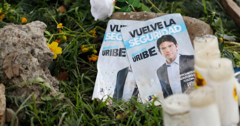 Images of Colombian Sen. Miguel Uribe Turbay, along with candles and flowers, lay at the site where he was shot during a political rally in Bogota, Colombia, on June 9.