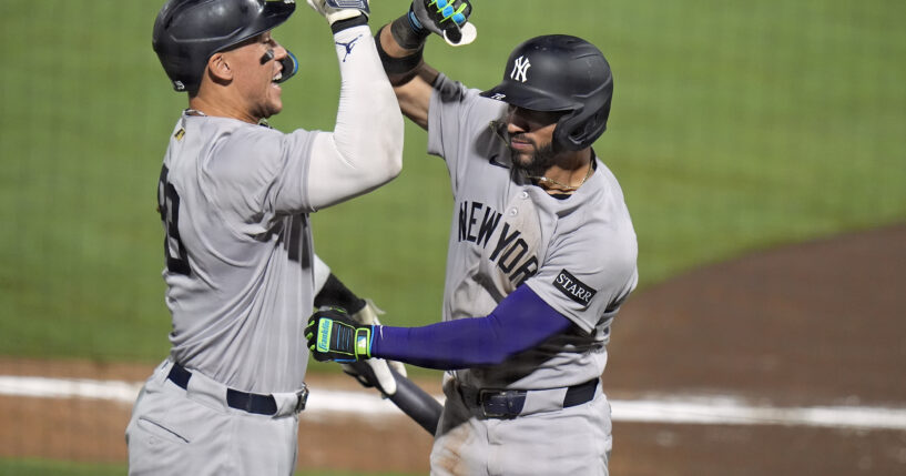 New York Yankees' José Caballero, right, celebrates his home run off Tampa Bay Rays pitcher Mason Montgomery with Aaron Judge, left, during the ninth inning of a baseball game in Tampa, Florida, on Tuesday.