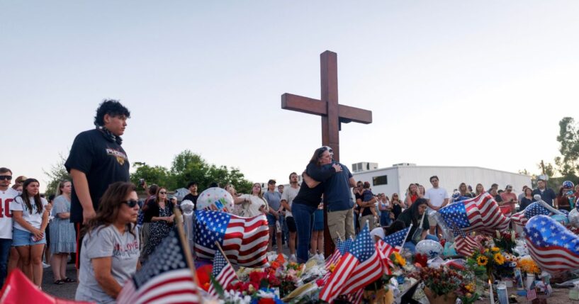 People visit a memorial for Charlie Kirk at the Turning Point USA headquarters on Sept. 12, 2025, in Phoenix, Arizona.