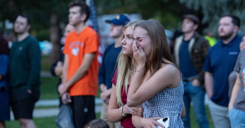 A young woman cries during a candlelight vigil for youth activist and influencer Charlie Kirk at a makeshift memorial at Orem City Center Park in Orem, Utah, a day after he was shot during a public event at Utah Valley University on Sept. 11, 2025.