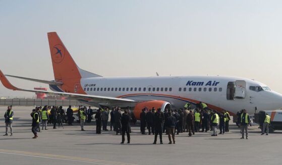 Kam Air employees gather by an airplane at a ceremony for Ukrainian employees of the Afghan airline at Kabul International Airport on Jan. 24, 2018, following their deaths in a Taliban attack on the Intercontinental Hotel.