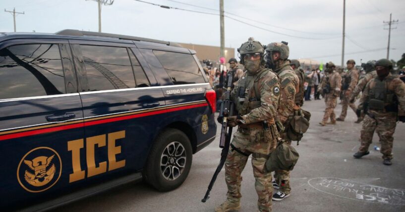 Immigration and Customs Enforcement agents armed with less-lethal weapons gather outside an ICE processing center during a protest in Broadview, Illinois, on Sept. 19, 2025.