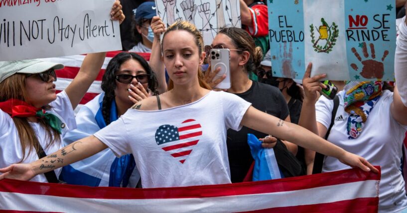 A young woman holds a U.S. flag during a protest in Los Angeles, California, on June 14, 2025.