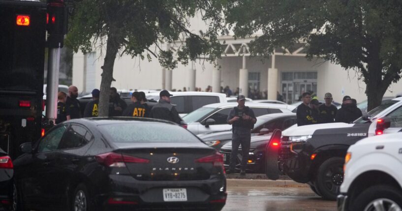 Law enforcement gather at a staging area close to a U.S. Immigration and Customs Enforcement office after a reported shooting, in Dallas, Texas, on Wednesday.