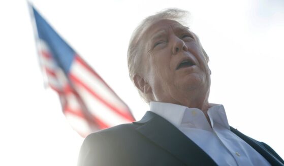 President Donald Trump speaks to members of the media as he departs the White House in Washington, D.C., on Friday.