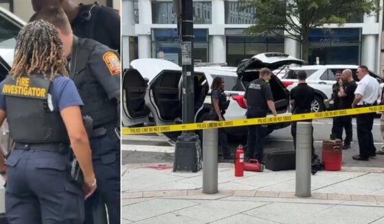 Fire investigators examine the Secret Service vehicle that caught fire Monday in Washington, D.C.
