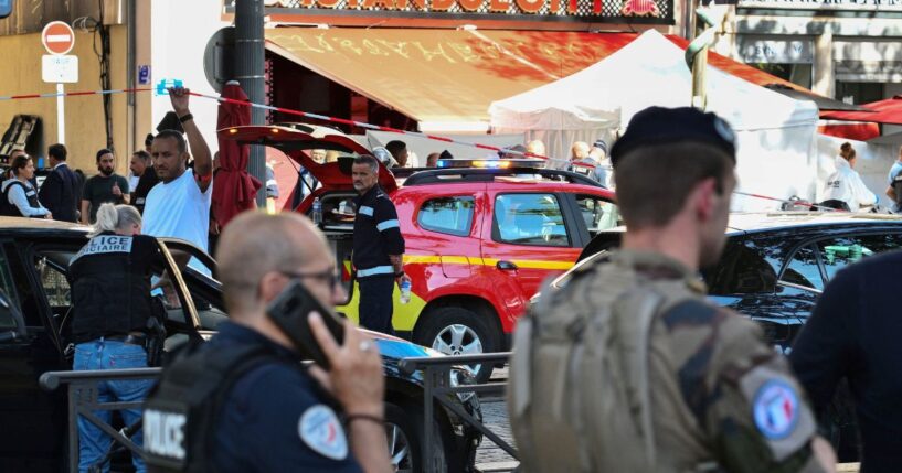 Police officers work at the site where French police shot dead a man suspected of stabbing five people in the centre of the southern port city of Marseille on Tuesday.
