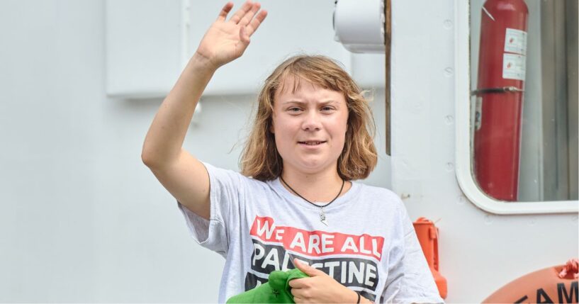 Greta Thunberg waves as she greets people while sailing on the Flotilla boat in Barcelona, Spain, on Sunday.
