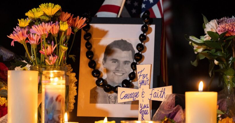 Candles and flowers sit near a portrait of conservative activist Charlie Kirk during a candlelight vigil in Provo, Utah, on Sept. 12, 2025.