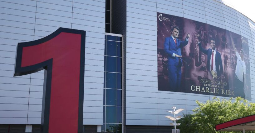 A giant poster displays a picture of Charlie Kirk on the side of State Farm stadium in Glendale, Arizona, on Sept. 20, 2025.
