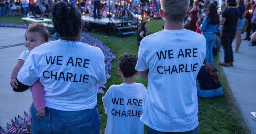 People wear shirts reading "we are Charlie" as they pay their respects to the late Charlie Kirk at a vigil in Provo, Utah, on Sept. 12, 2025.