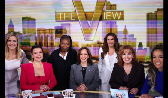 The cast of "The View" huddles around former Vice President Kamala Harris in New York on Oct. 8, 2024.