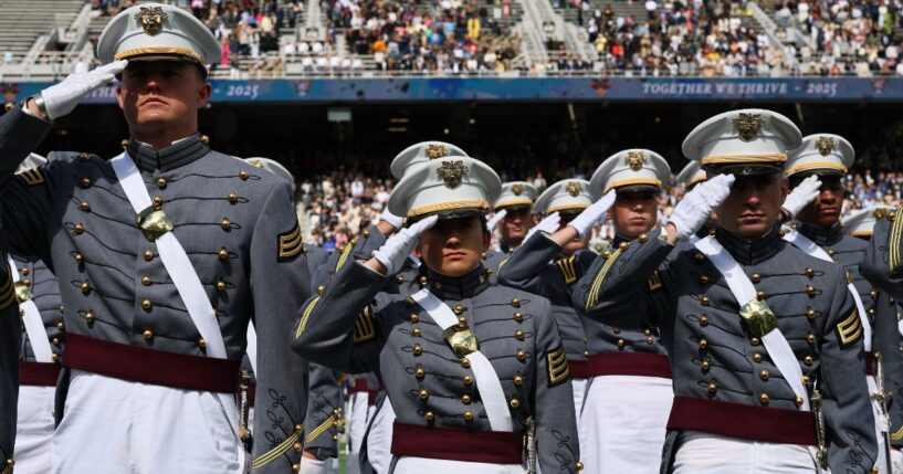 The graduating class of the United States Military Academy salutes as President Donald Trump arrives for a graduation ceremony at West Point in West Point, New York, on May 24.