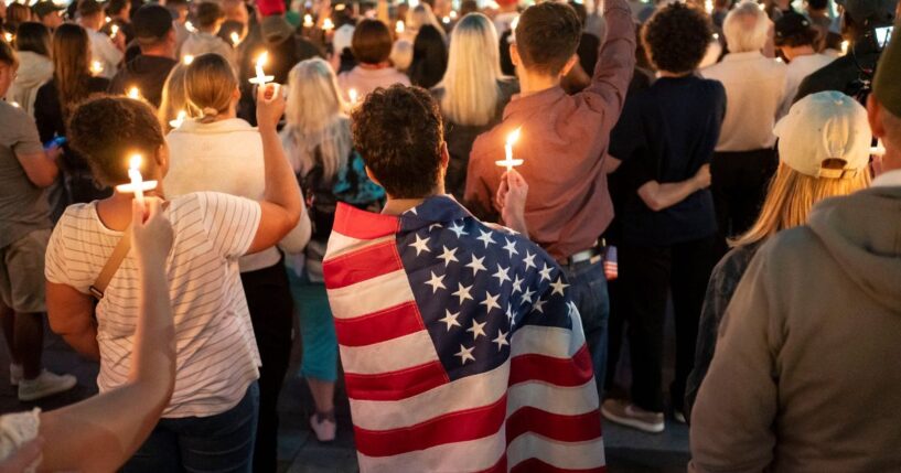 An attendee wears a U.S. flag during a candlelight vigil for Turning Point USA founder Charlie Kirk on Sept. 10, 2025, in Seattle, Washington.