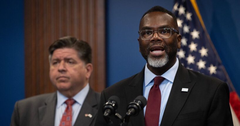 Illinois Gov. J.B. Pritzker listens as Chicago Mayor Brandon Johnson speaks at a news conference on Oct. 6, 2025, in Chicago, Illinois.