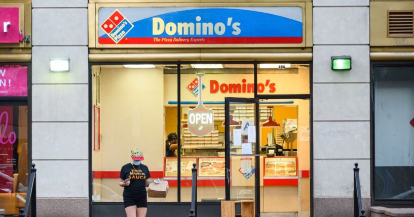 A person wears a protective face mask outside Domino's Pizza in Kips Bay as New York City on July 9, 2020.