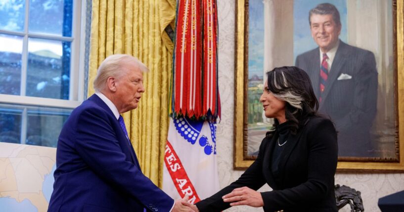 Director of National Intelligence Tulsi Gabbard shakes hands with President Donald Trump in the Oval Office at the White House on Feb. 12, 2025, in Washington, D.C.