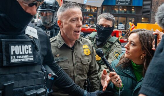 Border Patrol commander Gregory Bovino pushes through a crowd of media and protesters as he enters the Dirksen Federal Building Tuesday in Chicago, Illinois.