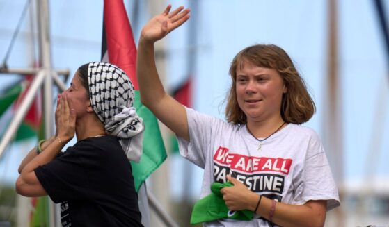 Swedish climate activist Greta Thunberg is seen waving from a boat taking part in a civilian flotilla bound for Gaza as the group left Barcelona, Spain, Aug. 31.