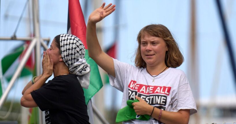 Swedish climate activist Greta Thunberg is seen waving from a boat taking part in a civilian flotilla bound for Gaza as the group left Barcelona, Spain, Aug. 31.
