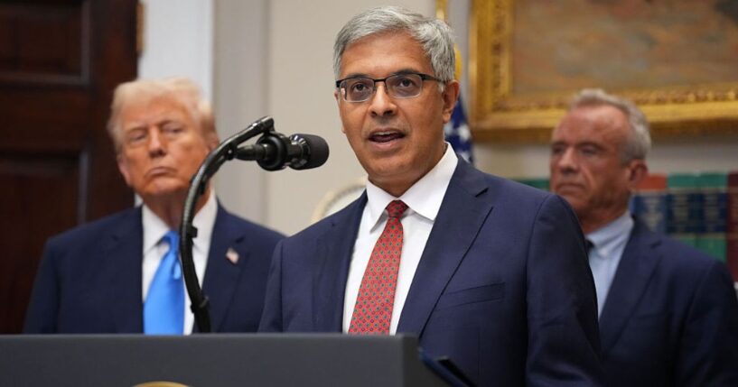 Director of the National Institutes of Health Jay Bhattacharya is seen at a September meeting with President Donald Trump, left, and Health and Human Services Secretary Robert F. Kennedy Jr., right.