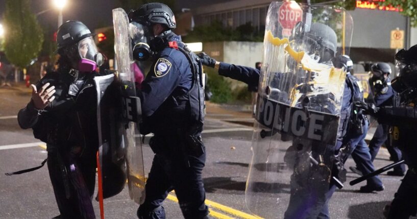 A rioter clashes with federal officers at an Immigration and Customs Enforcement detention facility in Portland, Oregon, on Aug. 20, 2020.