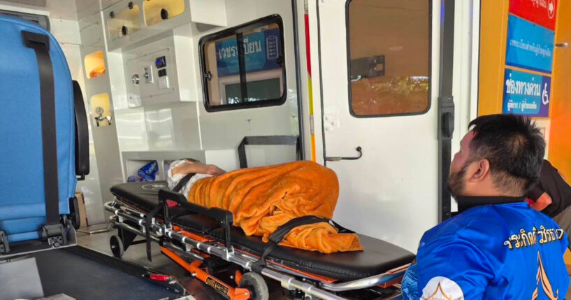 An emergency rescue team transports a woman discovered to be alive Sunday after being transported to a cremation facility at a Buddhist temple in Nonthaburi province, Thailand.