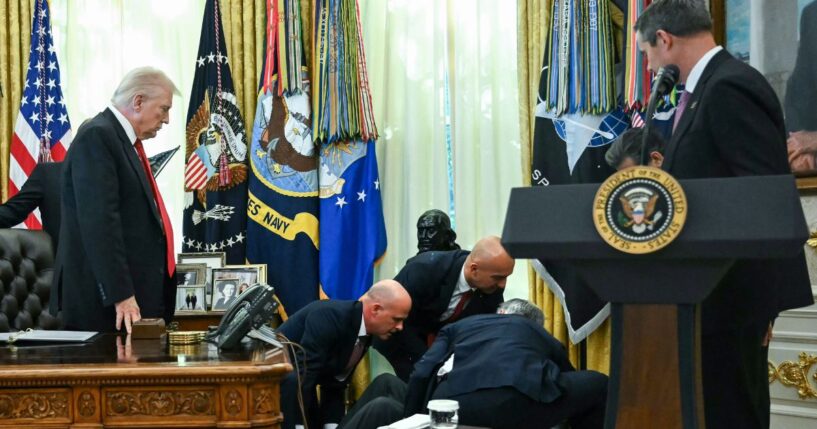 President Donald Trump looks on after a man fainted during an announcement about weight loss drugs in the Oval Office of the White House in Washington, D.C., on Nov. 6, 2025.