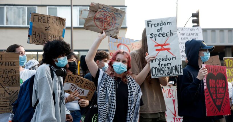 Protesters hold signs as they demonstrate outside of a Turning Point USA event at the University of California, Berkeley, on Nov. 10, 2025, in Berkeley, California.