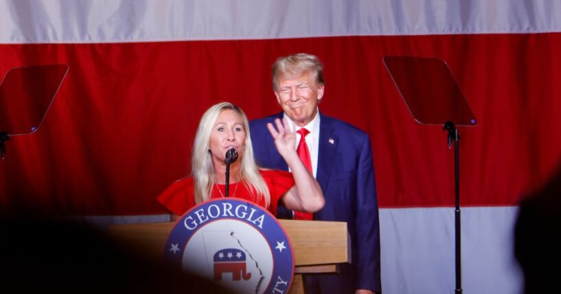 President Donald Trump looks on as Rep. Marjorie Taylor Greene speaks during his remarks at the Georgia state Republican convention at the Columbus Convention and Trade Center on June 10, 2023, in Columbus, Georgia.