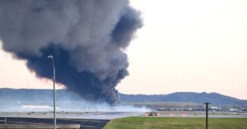 Fire and smoke mark where a UPS cargo plane crashed near Louisville Muhammad Ali International Airport on Nov. 4, 2025, in Louisville, Kentucky.