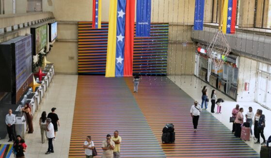 Travelers wait in the main hall of the Simon Bolivar Maiquetia International Airport in Maiquetia, Venezuela, on Nov. 23, 2025.
