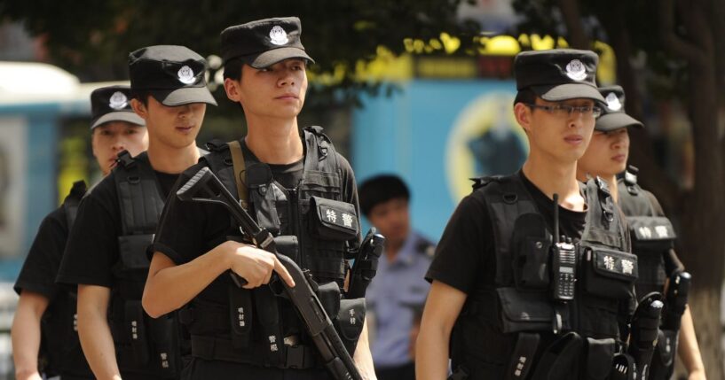 Armed Chinese police patrol a street in Urumqi, China in the Xinjiang region on July 3, 2010.