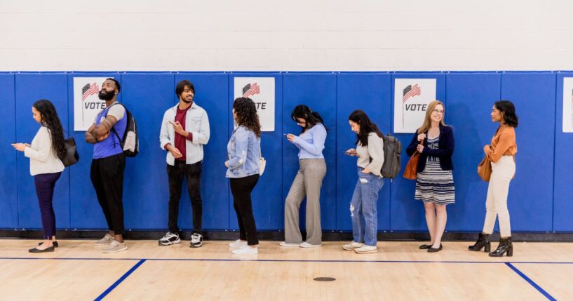 A group of voters stand in line at a community center so they can participate in early voting.